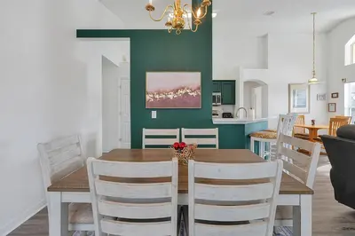 a dining room and kitchen with a table and chairs at Bikini Bottom - 4 bed Disney pool home in Kissimmee