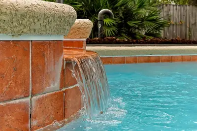a water fountain in a swimming pool at Castaway Getaway - Very popular 4 bed family pool home on Terra Verde Resort - close to Disney World in Kissimmee