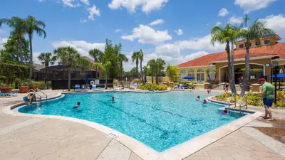a pool at a resort with people in it at Castaway Getaway - Very popular 4 bed family pool home on Terra Verde Resort - close to Disney World in Kissimmee