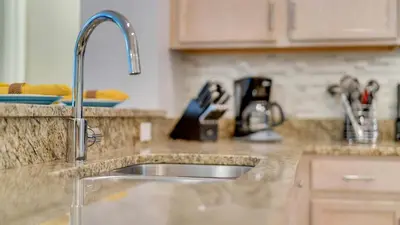 a kitchen counter top with a sink in a kitchen at Disney Backstage Villa - Stay in this popular 4 bed pool home that's very close to Disney in Orlando