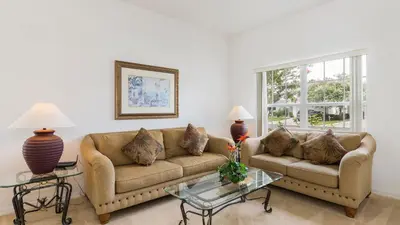 a living room with a couch and a table at Lucky Charm - Budget-friendly 5 bed vacation home, close to Disney World in Kissimmee