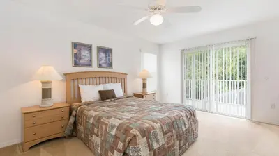 a bedroom with a bed and a ceiling fan at Lucky Charm - Budget-friendly 5 bed vacation home, close to Disney World in Kissimmee