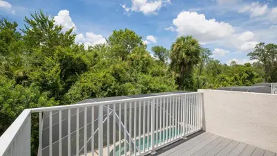 a balcony with a white fence and trees at Lucky Charm - Budget-friendly 5 bed vacation home, close to Disney World in Kissimmee