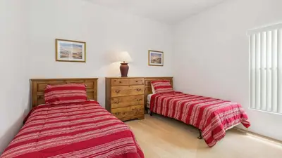 two beds in a bedroom with red striped sheets at Lucky Charm - Budget-friendly 5 bed vacation home, close to Disney World in Kissimmee