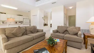 a living room with two couches and a table at Lucky Charm - Budget-friendly 5 bed vacation home, close to Disney World in Kissimmee