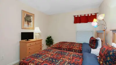 a bedroom with a bed and a tv on a dresser at Waterside Villa - Family 4 bed Emerald Island Resort pool home that's close to Disney World in Kissimmee