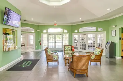 a dining room with green walls and a table and chairs at Waterside Villa - Family 4 bed Emerald Island Resort pool home that's close to Disney World in Kissimmee