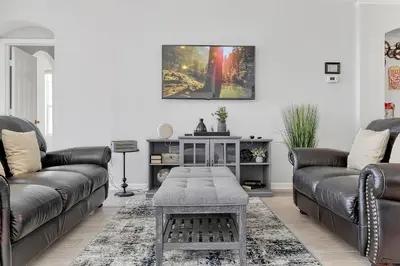 a living room with two leather couches and a table at Sunshine Station - Spacious 4 bed Windsor Palms resort home that's close to Disney in Kissimmee
