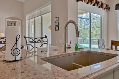 a kitchen with a sink and a counter top at Disney Magic Vacation - A fabulous 4 bed family pool home on Windsor Palms Resort - close to Disney World in Kissimmee