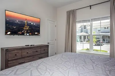 a bedroom with a bed and a large window at Luxurious 4Bd Home w/ Pool 4983 in Kissimmee