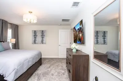 a bedroom with a bed and a large mirror at Luxurious 4Bd Home w/ Pool 4983 in Kissimmee