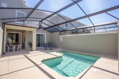 an indoor swimming pool in a house with an open ceiling at Luxurious 4Bd Home w/ Pool 4983 in Kissimmee