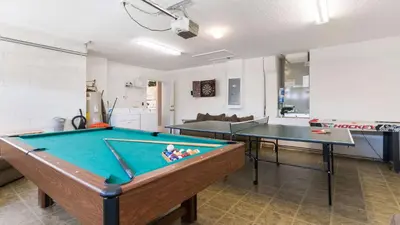 a living room with a pool table and two tables at Rhapsody Palms - Family 4-bed pool home that's close to Disney in Kissimmee