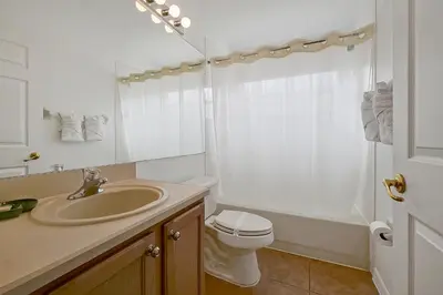 a bathroom with a sink and a toilet and a shower at Neptunes Retreat - 4 bed close to Disney in Kissimmee