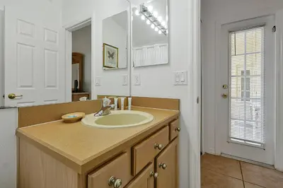 a bathroom with a sink and a mirror at Neptunes Retreat - 4 bed close to Disney in Kissimmee