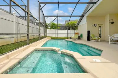a swimming pool with blue water in a building at Neptunes Retreat - 4 bed close to Disney in Kissimmee