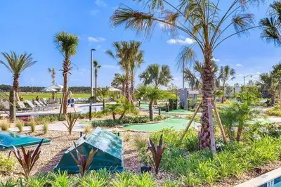 a golf course with palm trees in a resort at G - New 5 Bedroom Home - 5 Miles to Disney - Free Water Park - Private Pool in Kissimmee