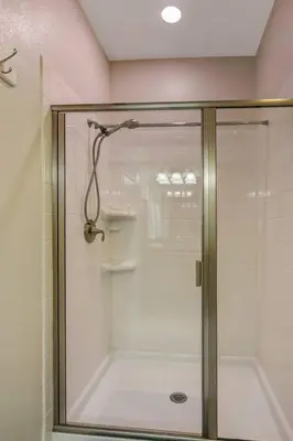 a shower with a glass door in a bathroom at G - New 5 Bedroom Home - 5 Miles to Disney - Free Water Park - Private Pool in Kissimmee