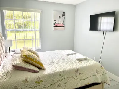 a bedroom with a bed with a television on the wall at Great Lovely Family Apartment close Disney in Kissimmee