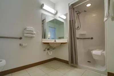 a bathroom with a shower and a sink and a toilet at Motel 6-Kissimmee, FL - Orlando in Orlando