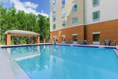 a swimming pool in front of a building at Candlewood Suites - Orlando - Lake Buena Vista by IHG in Orlando