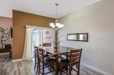 a dining room with a table and chairs at F - New 4 Bedroom Home - 5 Miles to Disney - Free Water Park - Private Pool in Kissimmee