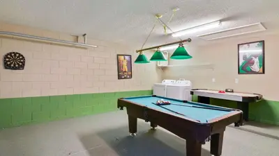 a pool table in a room with green at Shooting Star - Family friendly 4 bed pool home on Emerald Island Resort - close to Disney World! in Kissimmee