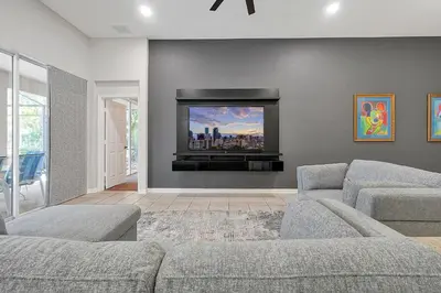 a living room with two couches and a flat screen tv at Mickey's Ranch - 4 bed pool home - Windsor Hills in Orlando