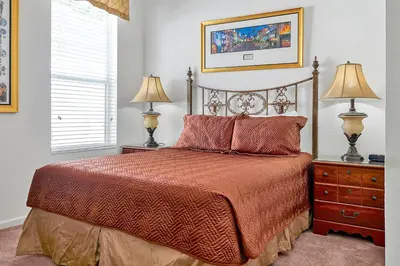 a bedroom with a bed with two lamps and two night stands at Mickey's Ranch - 4 bed pool home - Windsor Hills in Orlando