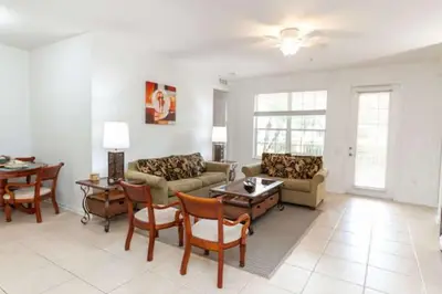 a living room with a couch and chairs and a table at 5min Universal Spacious Condo VC101 in Orlando