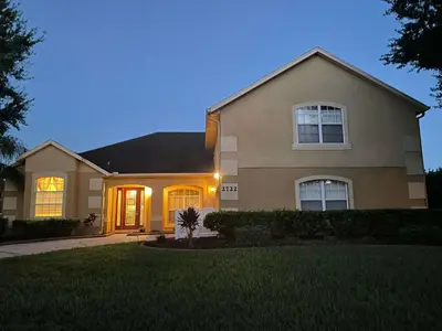a house with its lights on in the yard at Closest to Disney in Orlando