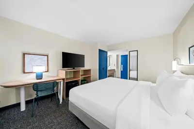 a hotel room with a bed and a desk at Spark by Hilton Orlando near Universal in Orlando
