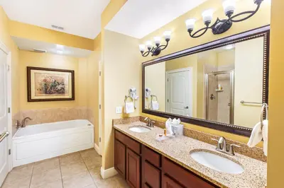 a bathroom with two sinks and a large mirror at The Berkley, Orlando in Orlando
