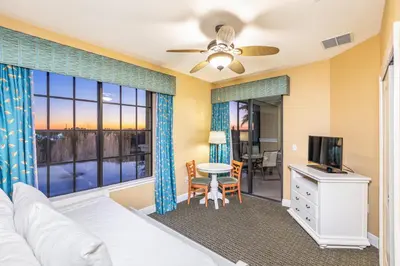 a bedroom with a bed and a television and a table at The Berkley, Orlando in Orlando