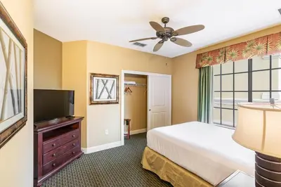 a bedroom with a bed and a flat screen tv at The Berkley, Orlando in Orlando