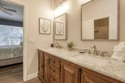 a bathroom with a sink and a mirror at Disney Daze Villa - 5 bed Windsor Hills pool home in Orlando
