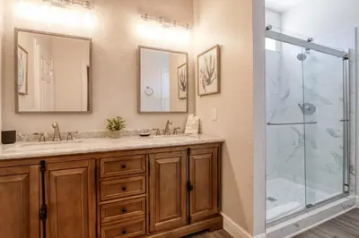 a bathroom with a double sink and a shower at Disney Daze Villa - 5 bed Windsor Hills pool home in Orlando
