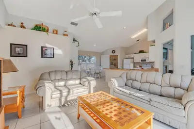 a living room with two couches and a table at Quiet Home With Private Pool- Near Disney in Kissimmee