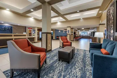 a lobby of a hospital with couches and chairs at Best Western Plus Orlando East - UCF Area in Orlando
