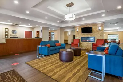 a living room with blue couches and a fireplace at I-Drive Hotel at Universal in Orlando