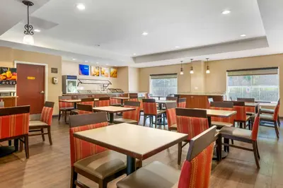 a dining room with tables and chairs in a restaurant at I-Drive Hotel at Universal in Orlando