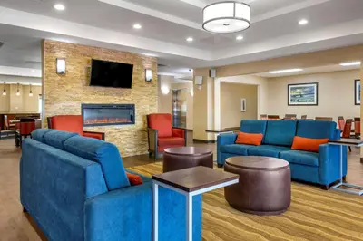 a lobby with blue furniture and a fireplace at I-Drive Hotel at Universal in Orlando