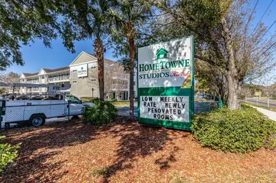 a sign in front of a house at HomeTowne Studios by Red Roof Orlando - Casselberry in Orlando