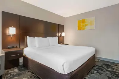a large white bed in a hotel room at City Express by Marriott Orlando International Drive in Orlando