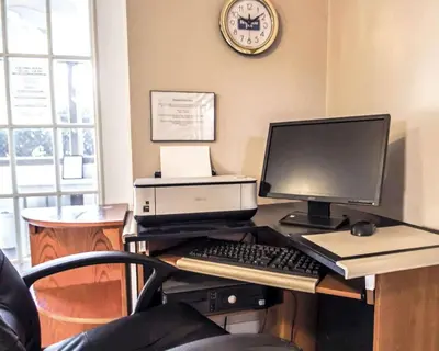 an office with a desk with a computer and a printer at Rodeway Inn Apopka South in Orlando
