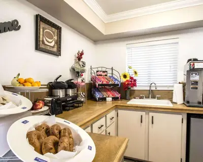 a kitchen with a bowl of food on a counter at Rodeway Inn Apopka South in Orlando