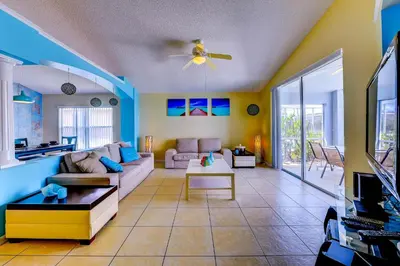 a living room with a couch and a table at Fascinating Lake View With Private Pool And Game-Room, Near Disney!! in Kissimmee