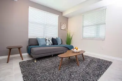 a living room with a couch and a table at Gorgeous Two Bedroom Apto Close to Disney 306 in Kissimmee