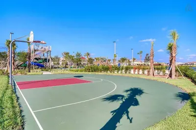 a shadow of a person on a tennis court at B - New 4 Bedroom Home - 5 Miles to Disney - Free Water Park - Private Pool in Kissimmee