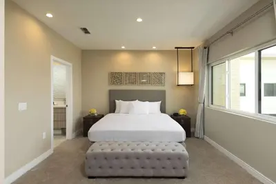 a bedroom with a large bed and a large window at Magic Village Views Trademark Collection by Wyndham in Orlando